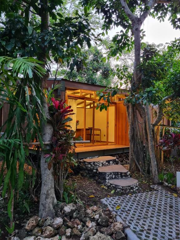 a house in the middle of a garden at Grün Resort Uluwatu in Uluwatu