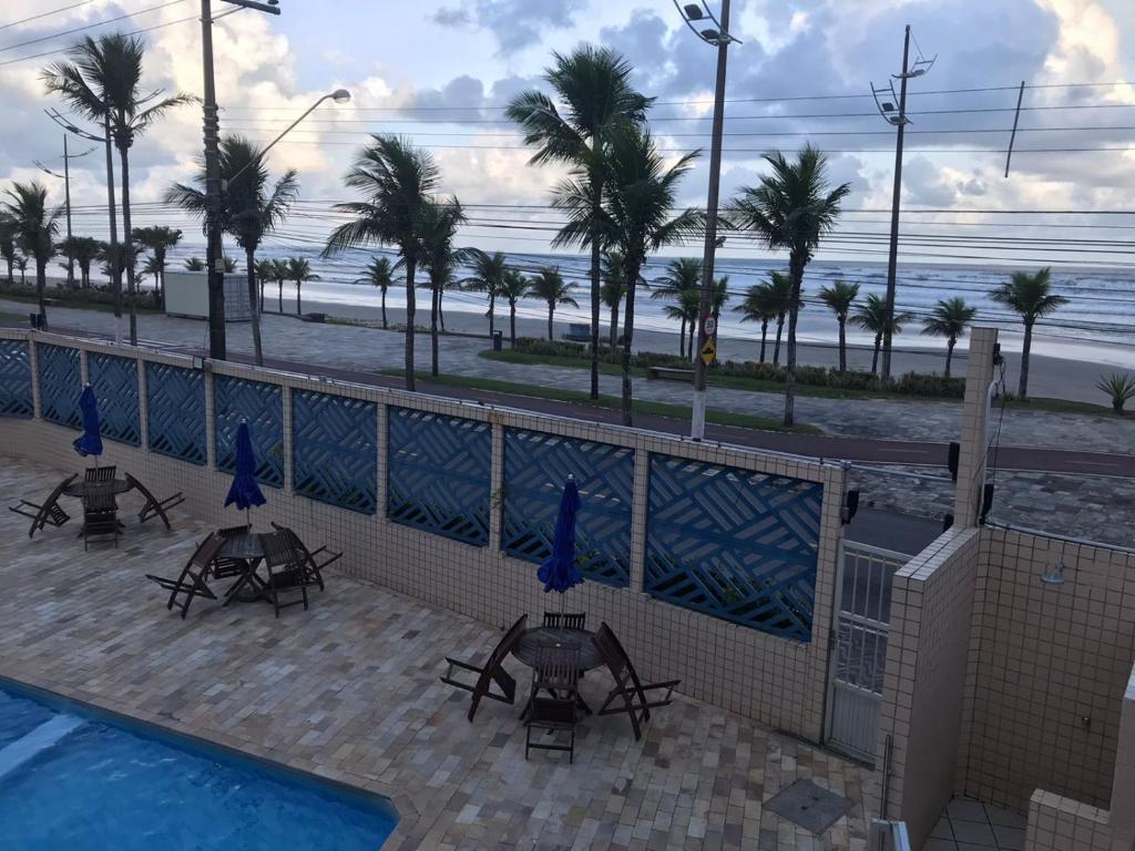 a view of the beach from the balcony of a resort at Pousada dos Eletricitarios in Praia Grande