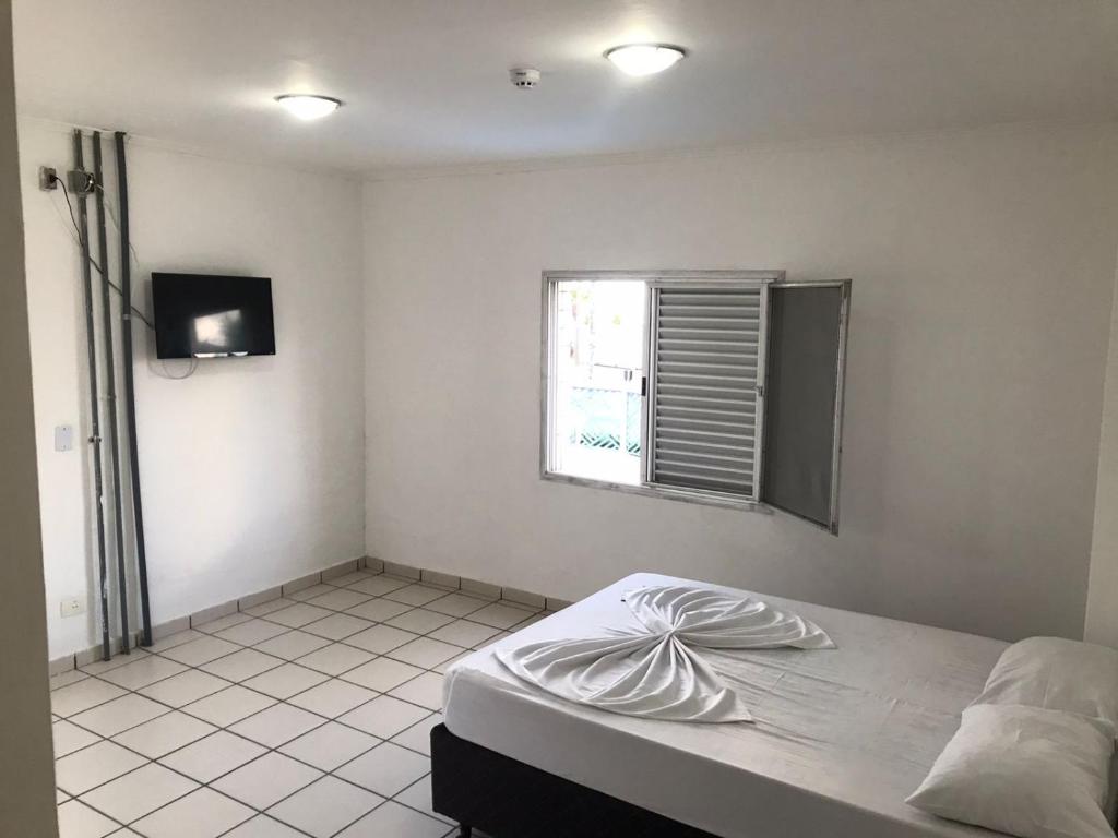 Cama ou camas em um quarto em Pousada dos Eletricitarios