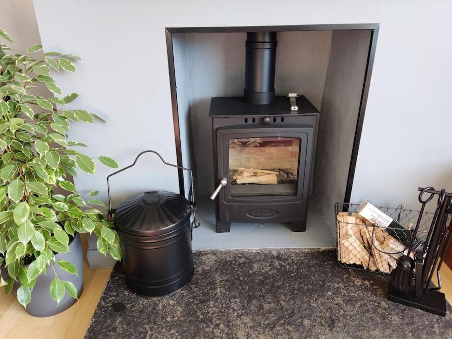 a black stove in a room with a trash can at Self-catering in Portree in Portree