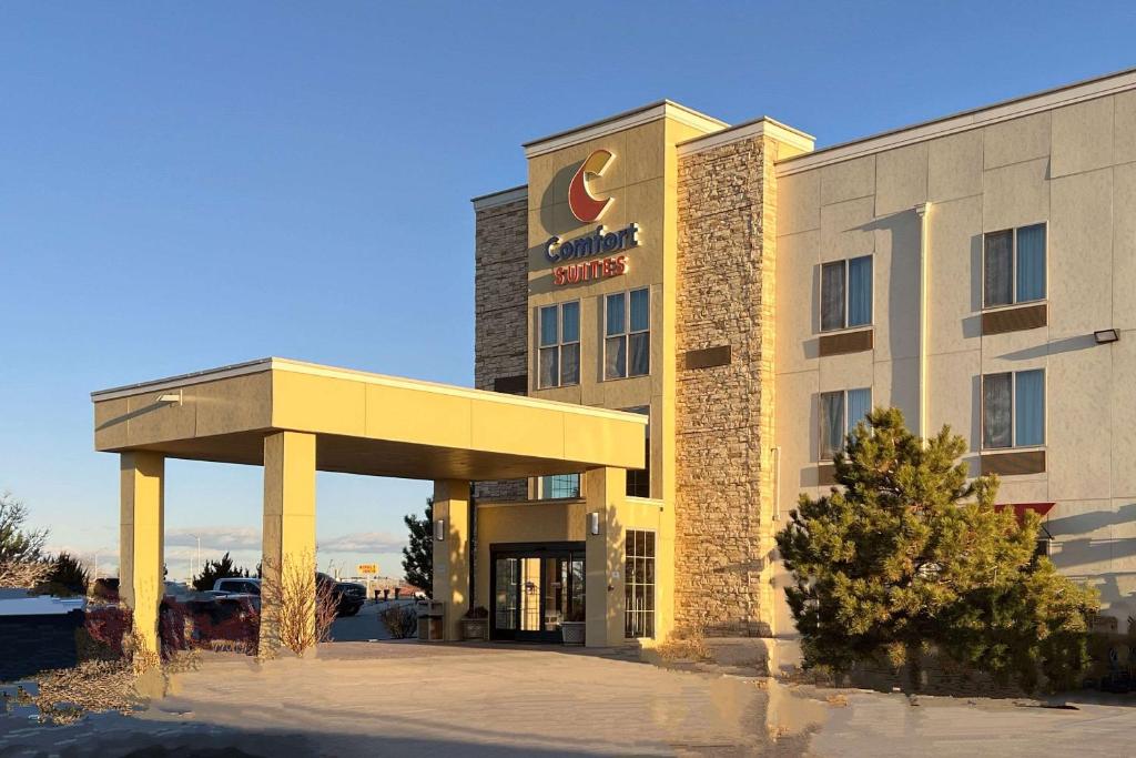 a hotel with a sign on the front of it at Comfort Suites Farmington in Farmington