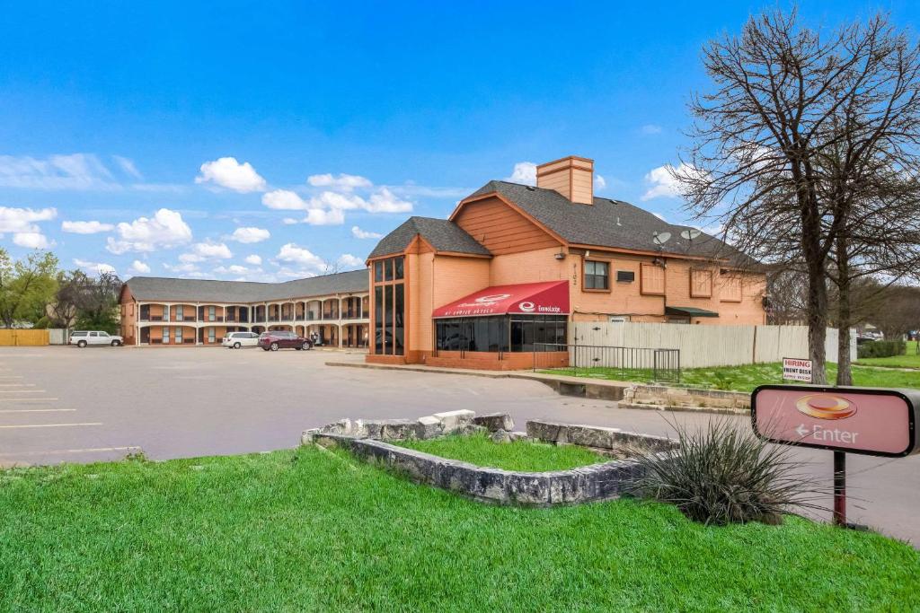 a building with a sign in front of a parking lot at Econo Lodge near The Domain - The Arboretum in Austin