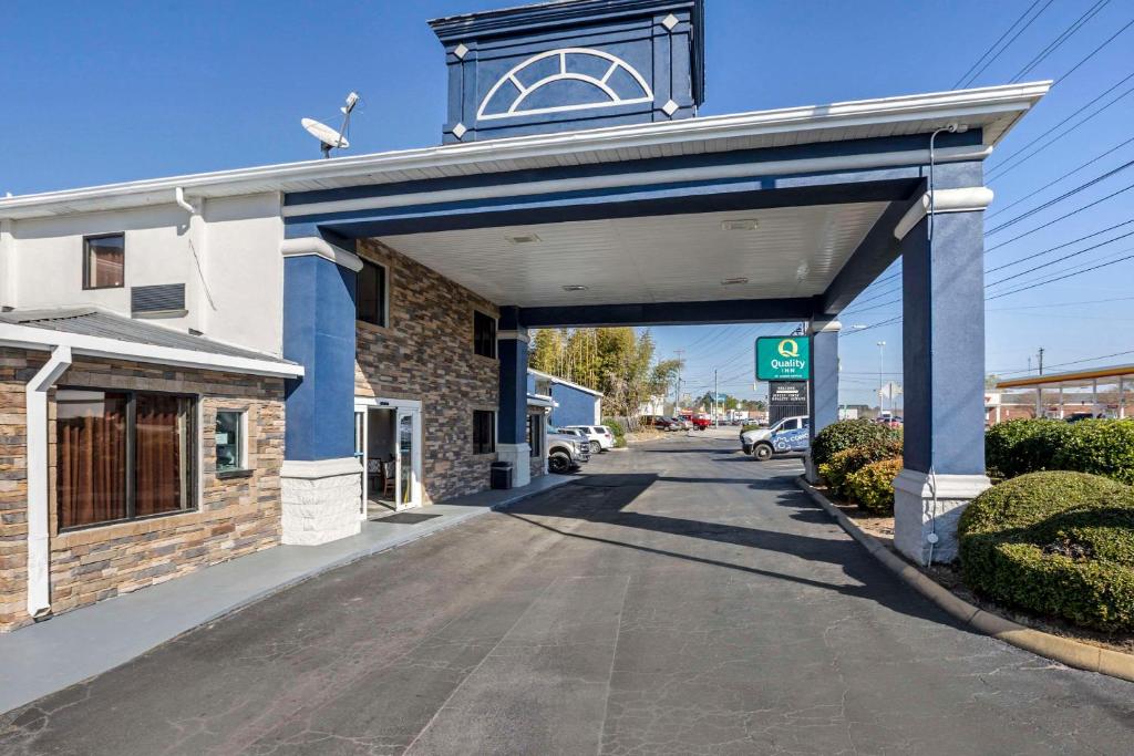 a gas station with a blue archway on a street at Quality Inn in Newberry