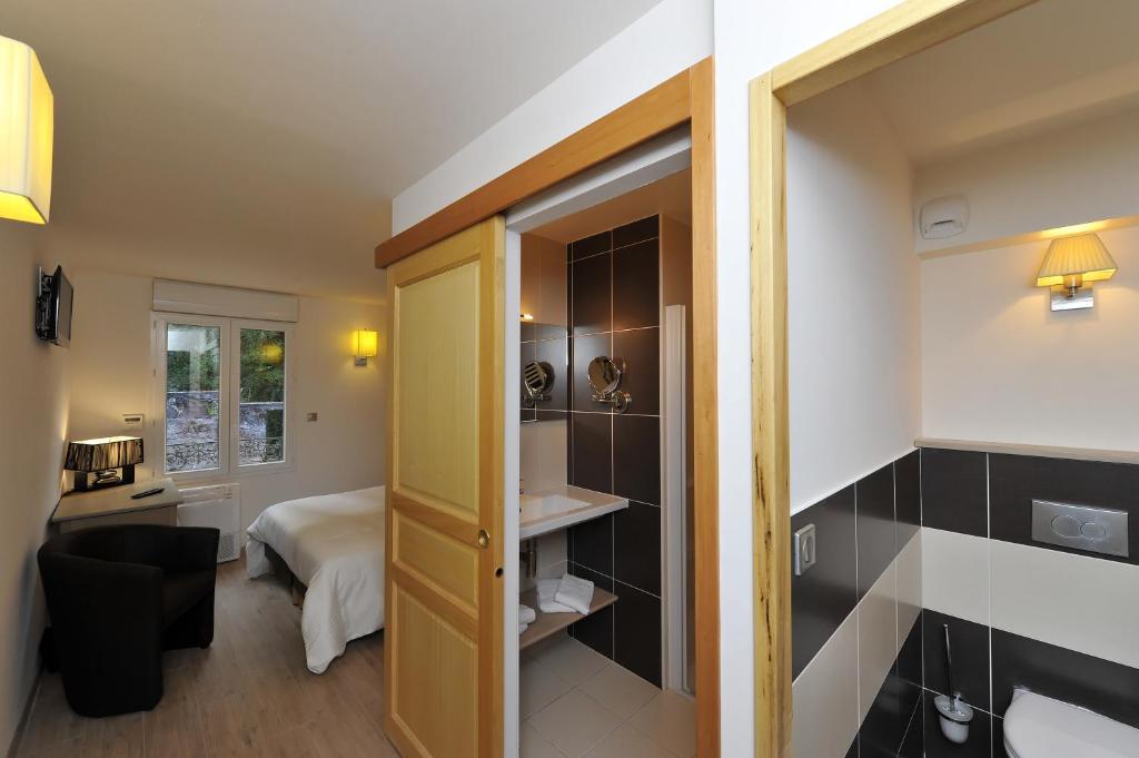 Postel nebo postele na pokoji v ubytování Logis Hôtel Restaurant Les 2 Rives - A75, en bordure de rivière