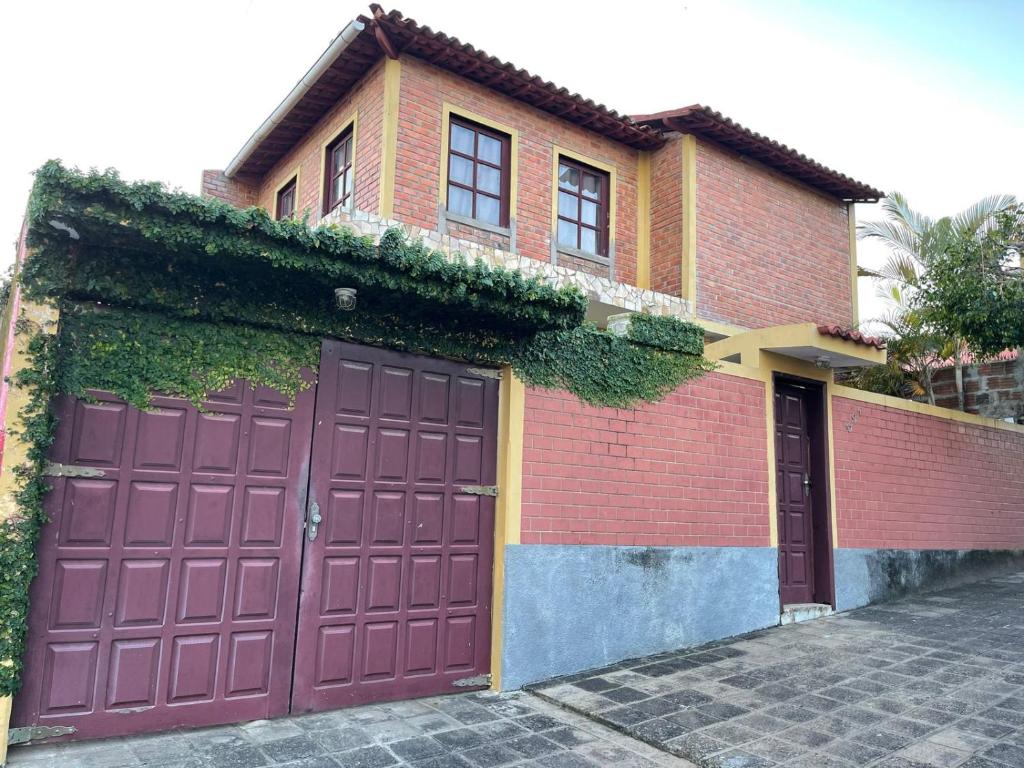 a house with two garage doors in front of it at Casa amanhecer in Triunfo