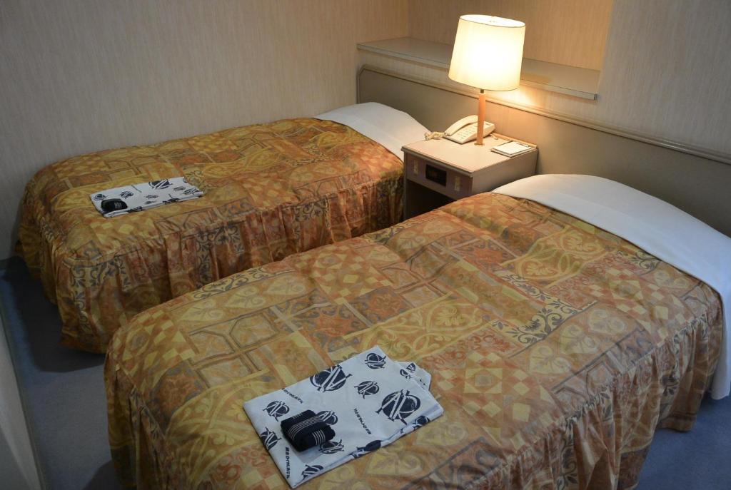 a hotel room with two beds with cameras on them at Abashiri Royal Hotel in Abashiri