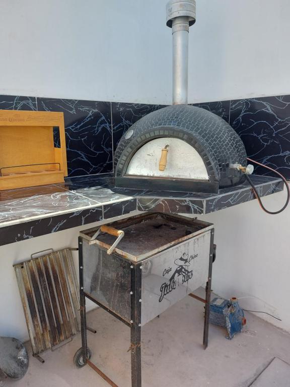 a pizza oven sitting on top of a counter at Casa de playa con piscina en estreno in Camaná