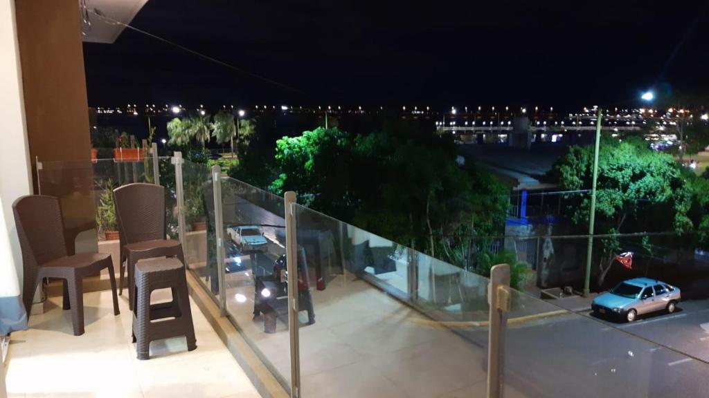 a balcony with a car on the road at night at VB Home in Posadas