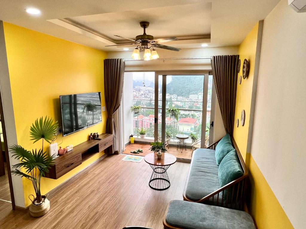 a living room with a couch and a tv at Mon Sapphire Homestay * View Sea and Poem Mountain in Ha Long