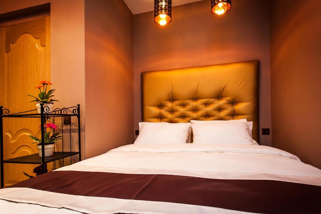 a bedroom with a large bed with a large headboard at Leo Hotel in Moscow