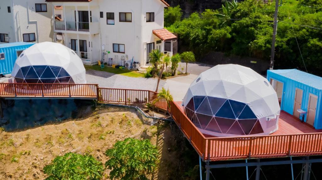 two domes on a deck in front of a house at HIKARI DOME - Vacation STAY 49575v in Teruma