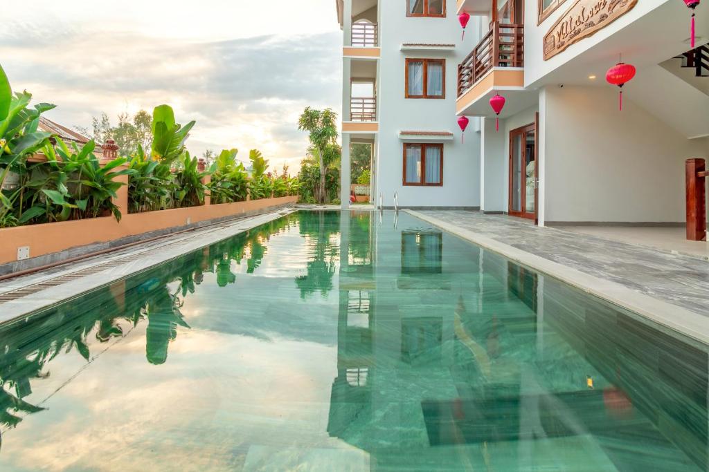 a swimming pool in the middle of a building at Villa Loan A HOI AN in Hoi An
