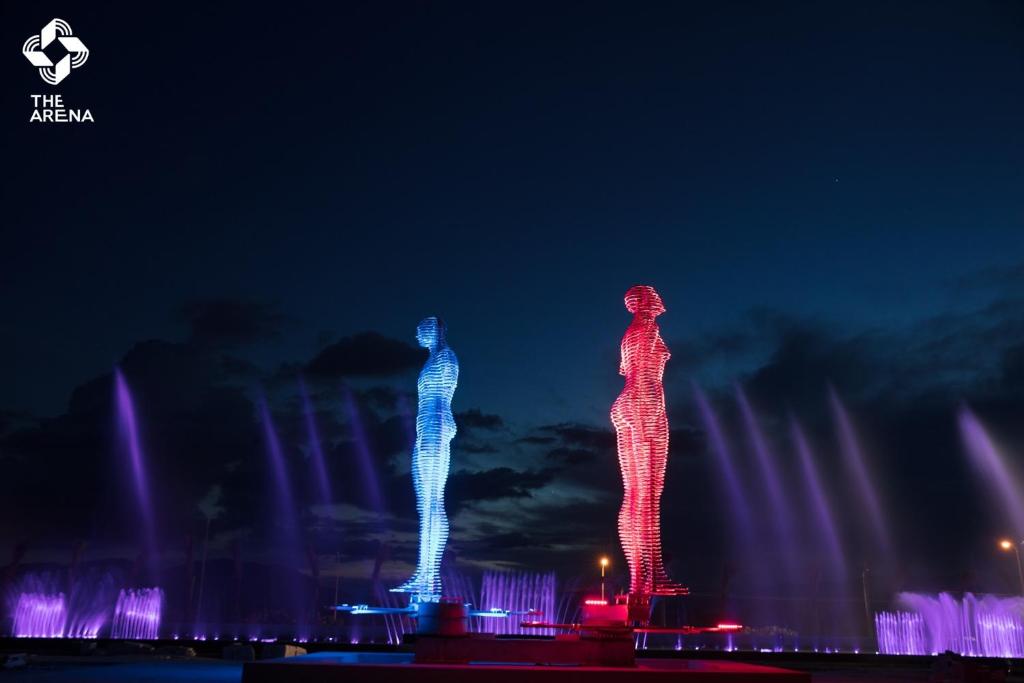 two lit up figures in front of a fountain at night at Bluesky Home Cam Ranh Khánh Hòa in Cam Ranh
