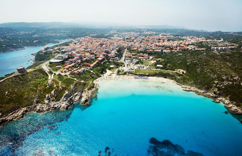 an aerial view of a beach with blue water at Smart Suite & Apartments in Santa Teresa Gallura