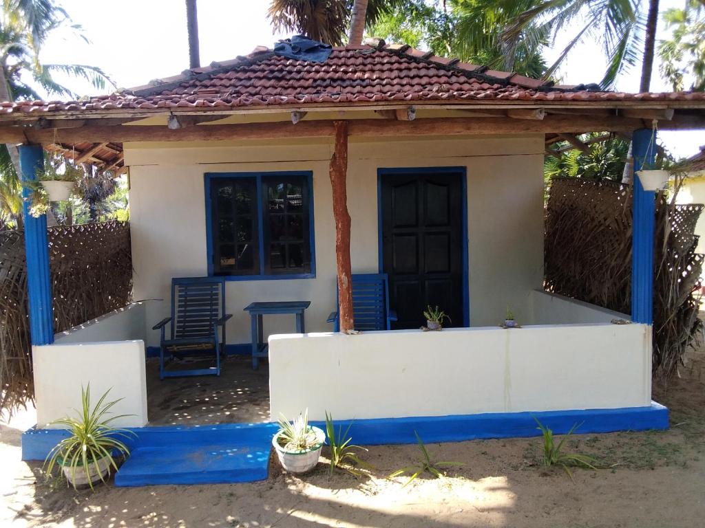 una pequeña casa con un exterior azul y blanco en araliya villa, en Kalpitiya
