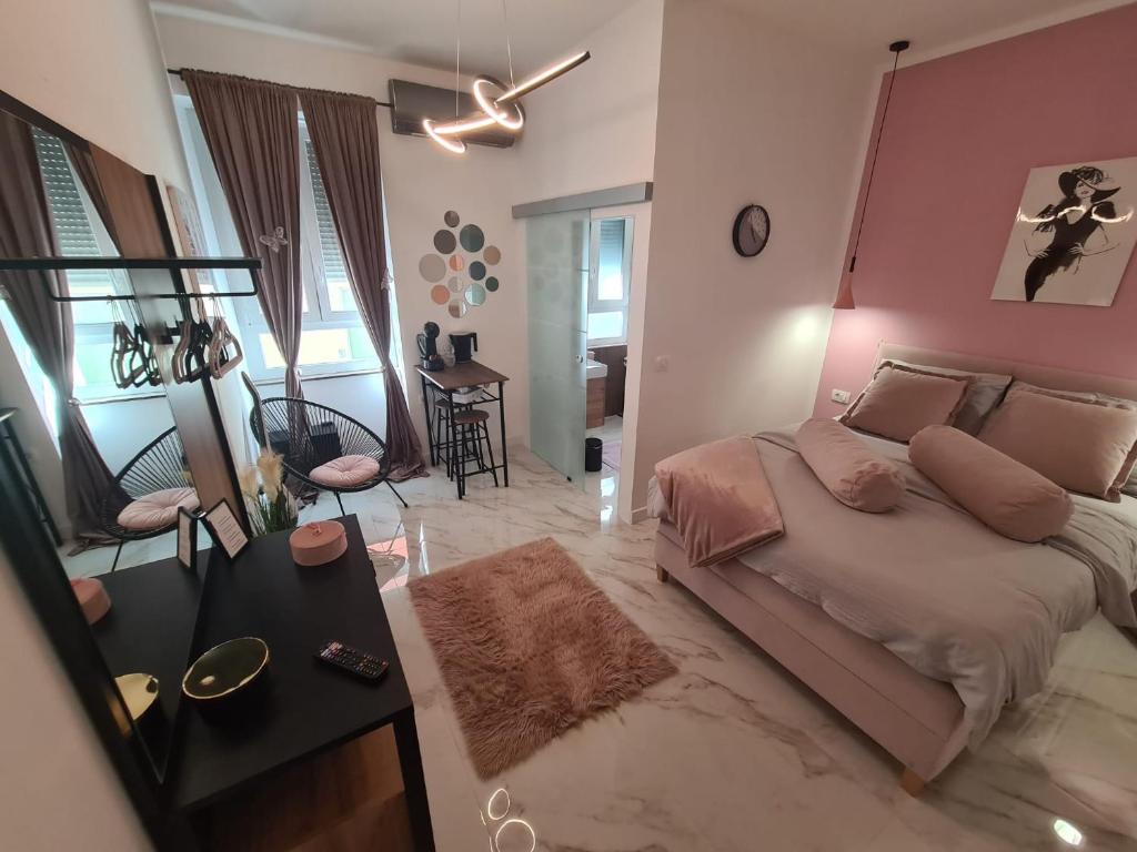 a bedroom with a bed and a pink wall at Premium class Room in Zadar