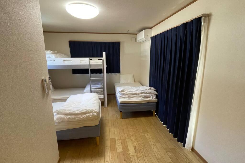 Postel nebo postele na pokoji v ubytování 富士山下Cottage-B