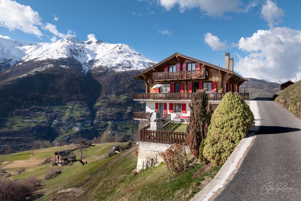 a house on the side of a road with a mountain at Gaby in Grächen