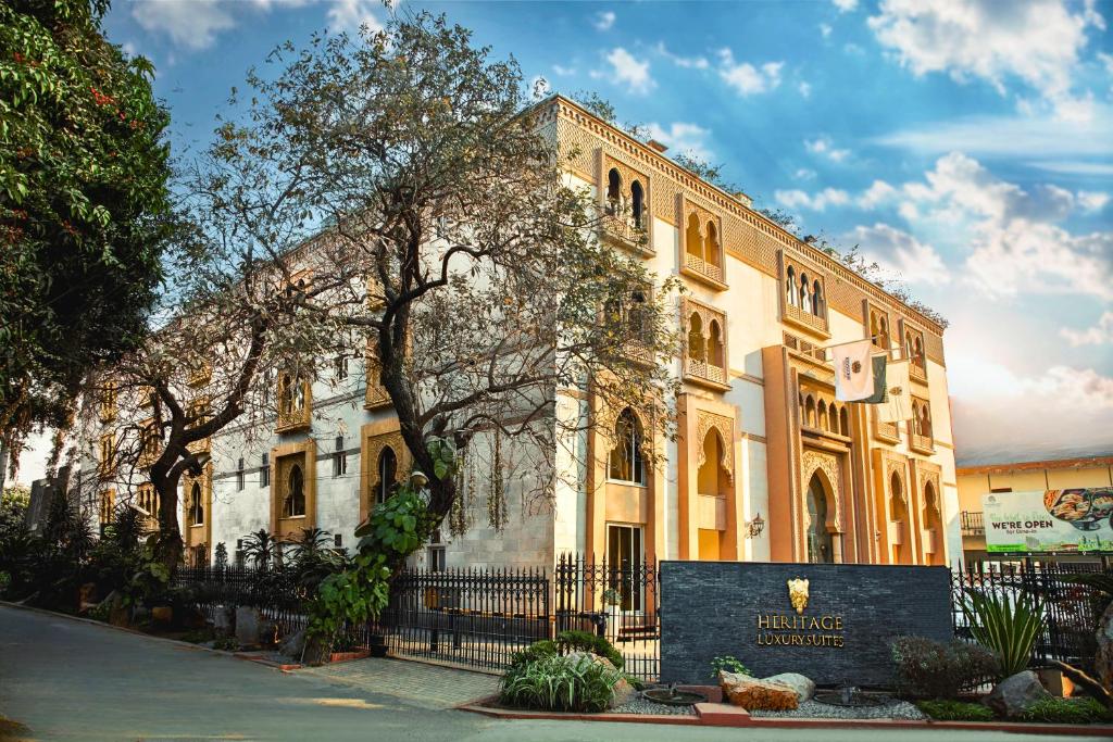 un edificio con una señal delante de él en Heritage Luxury Suites All Suite Hotel, en Lahore