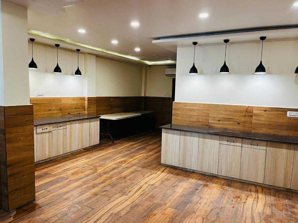 a large room with wood paneling and a waiting room at OYO Hotel Happy Homes in Bhopal