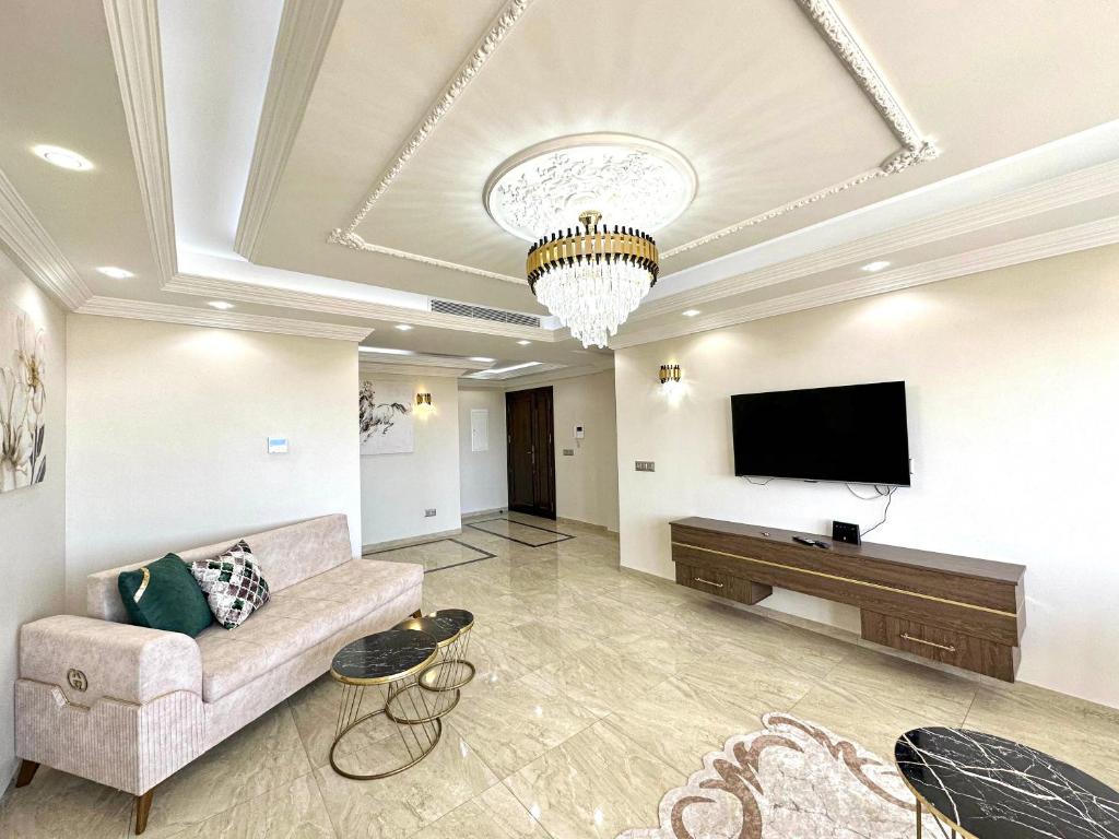 a living room with a couch and a flat screen tv at Luxury 3 Bedrooms Apartment Sea View in Rejiche