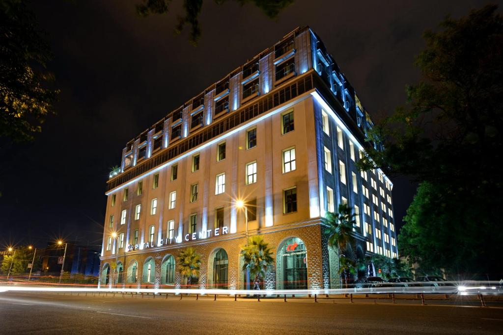 a building is lit up at night at Capital City Center Apart Residence in Plovdiv