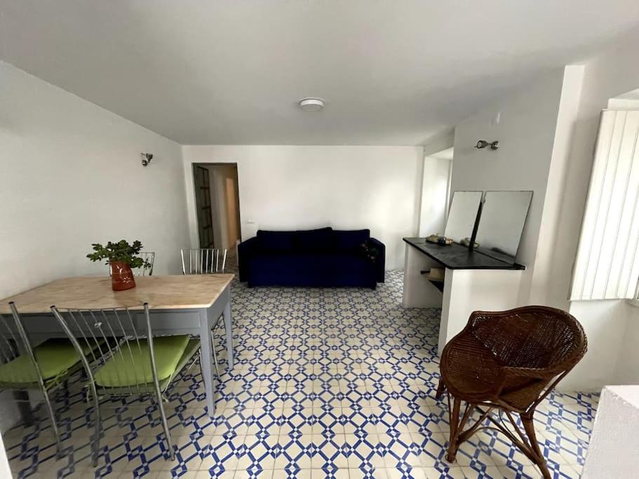 a living room with a table and chairs and a couch at Puskin Suite in Sines