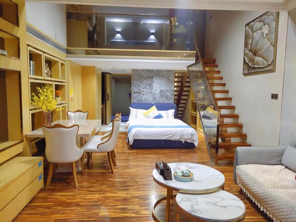 a living room with a bed and a staircase at Guangzhou Laixizhou Pazhou Aparthotel - Enjoy free Shuttle Bus & Guidance Service in Canton Fair in Guangzhou
