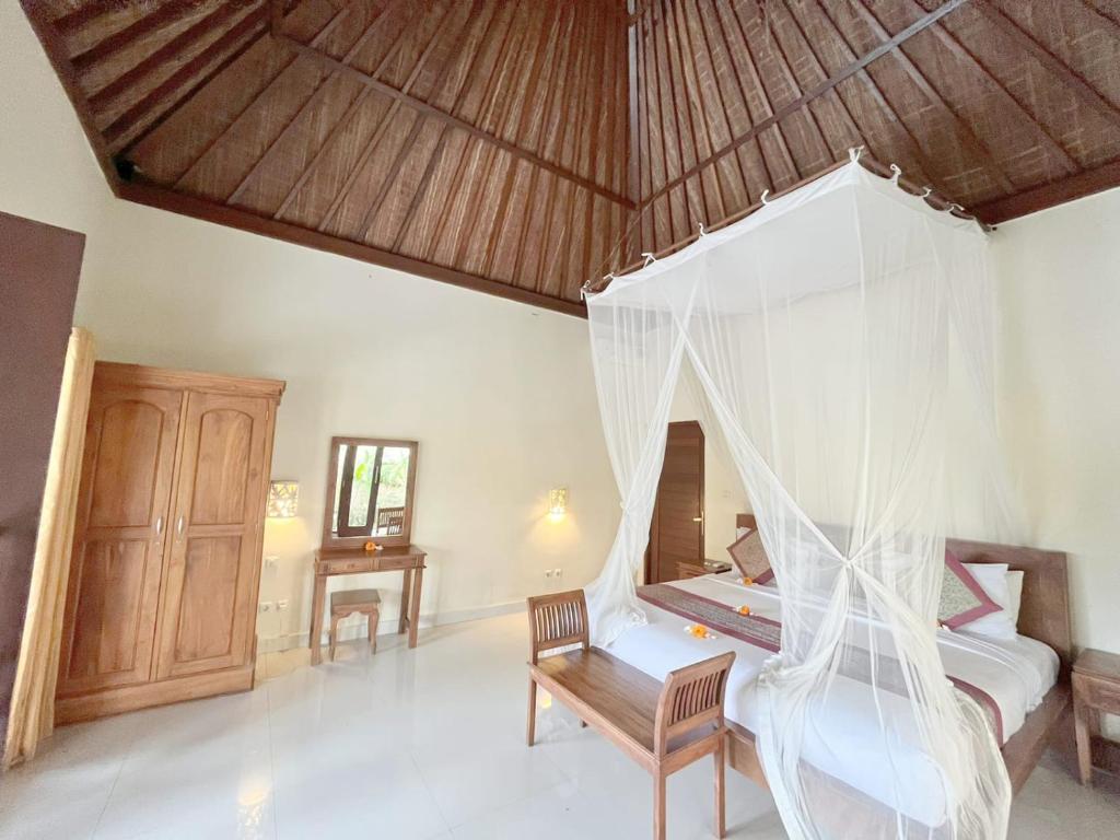 Postel nebo postele na pokoji v ubytování Intan Villa & Suite Ubud