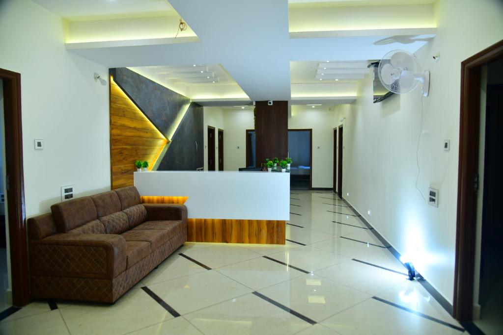 a living room with a couch and a white counter at RK COMFORTS in Bangalore