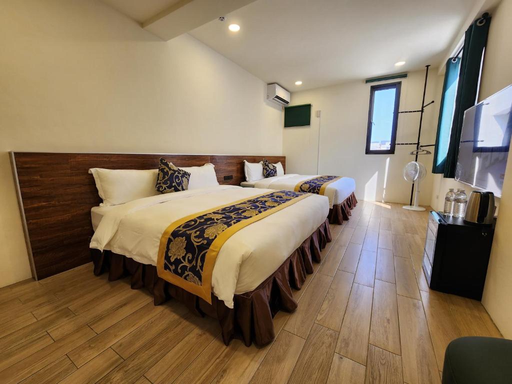 Postel nebo postele na pokoji v ubytování Penghu Dayou View B&B