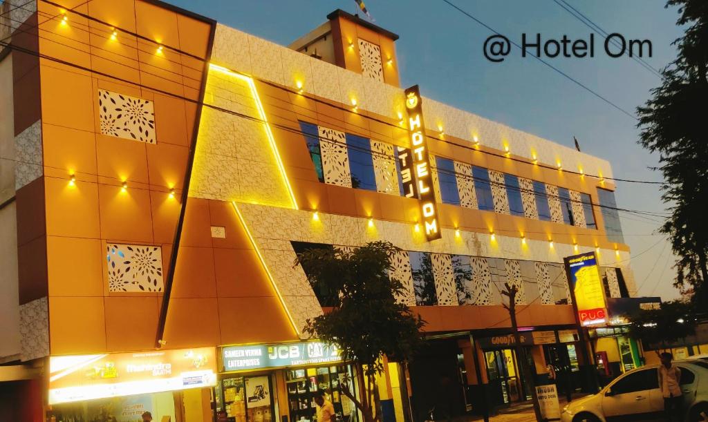 a building with lights on the side of it at Hotel Om in Betūl