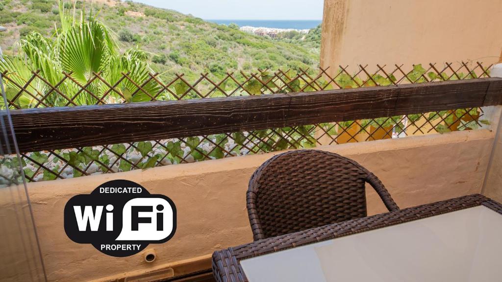 a chair sitting on a balcony with a view at Duquesa Village 7,19,12 in Manilva