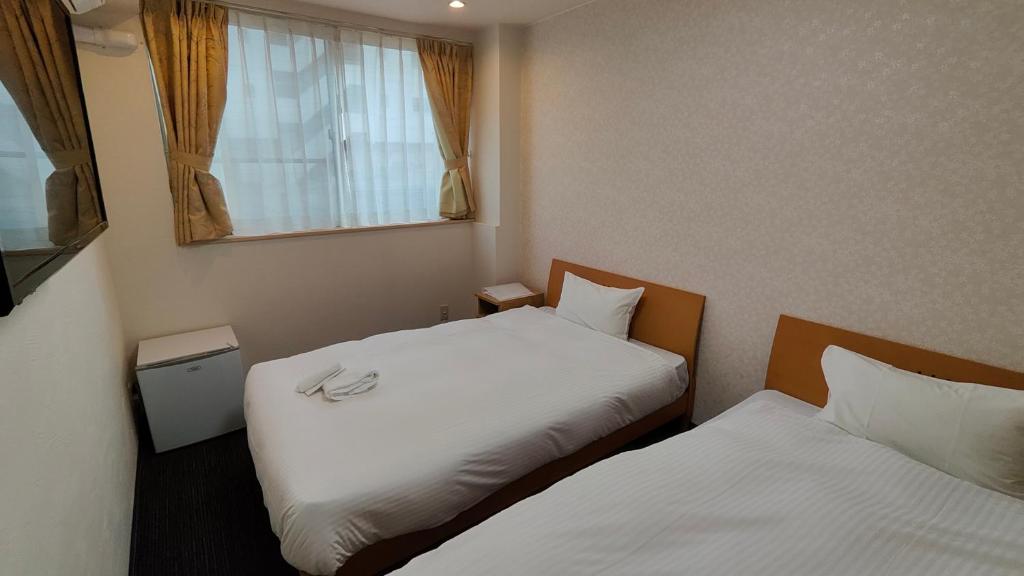 Postel nebo postele na pokoji v ubytování Dotonbori Shinsaibashi Hotel