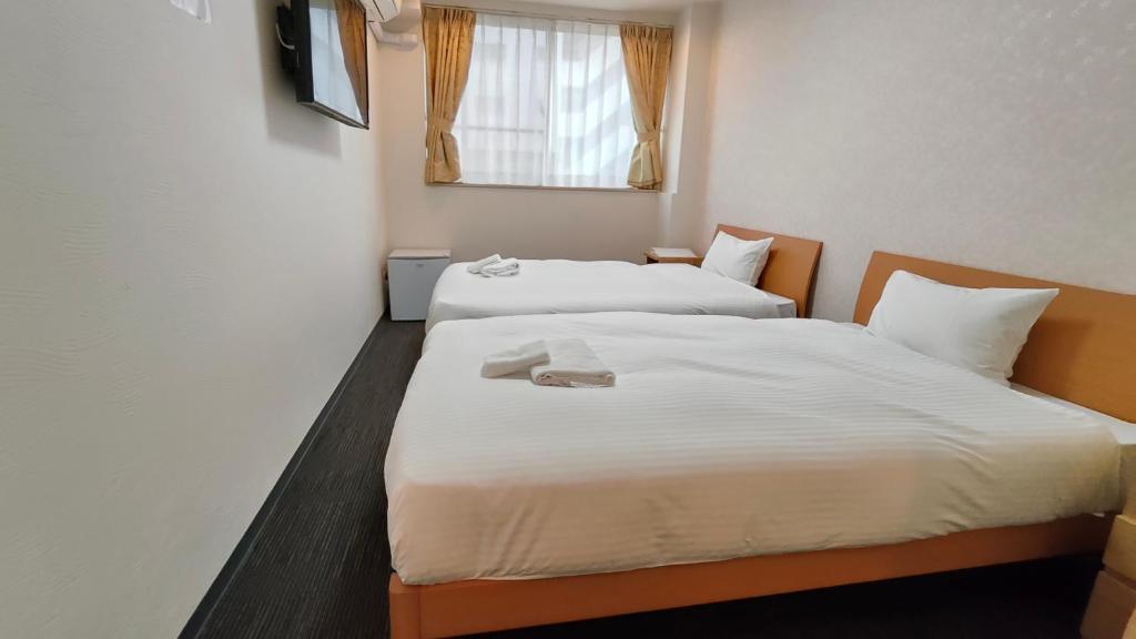 Postel nebo postele na pokoji v ubytování Dotonbori Shinsaibashi Hotel