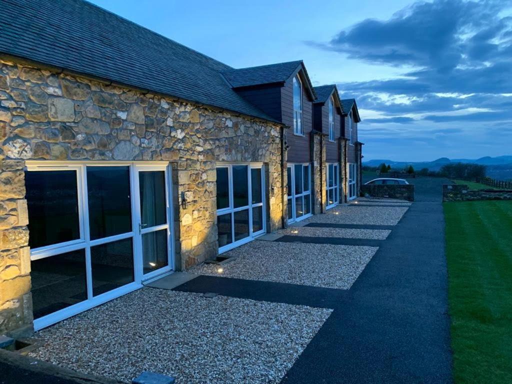 a stone building with a walkway in front of it at Woodside Apartments in St Andrews