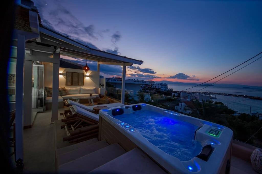 a hot tub on the balcony of a house at The View in Megalochori
