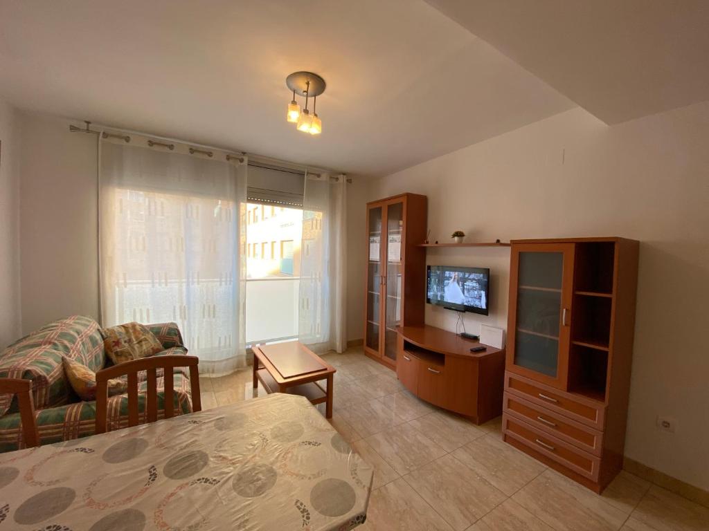 a living room with a couch and a television at Joan XXIII Apartment in Tarragona