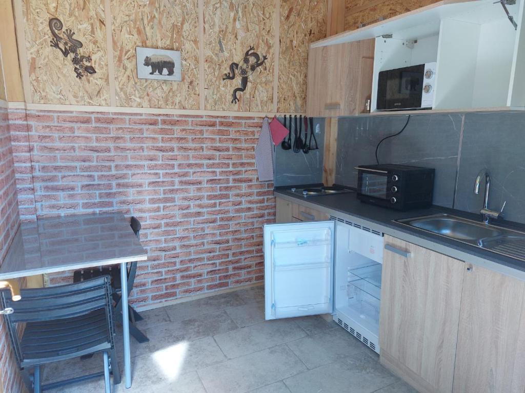 a small kitchen with a counter and a microwave at Mike's Rooms in Kobarid
