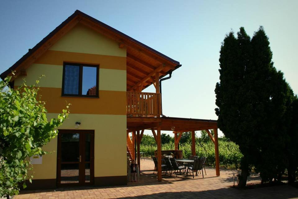 Šakvice的住宿－PENZION POD PALAVU，房屋前方设有甲板和桌子