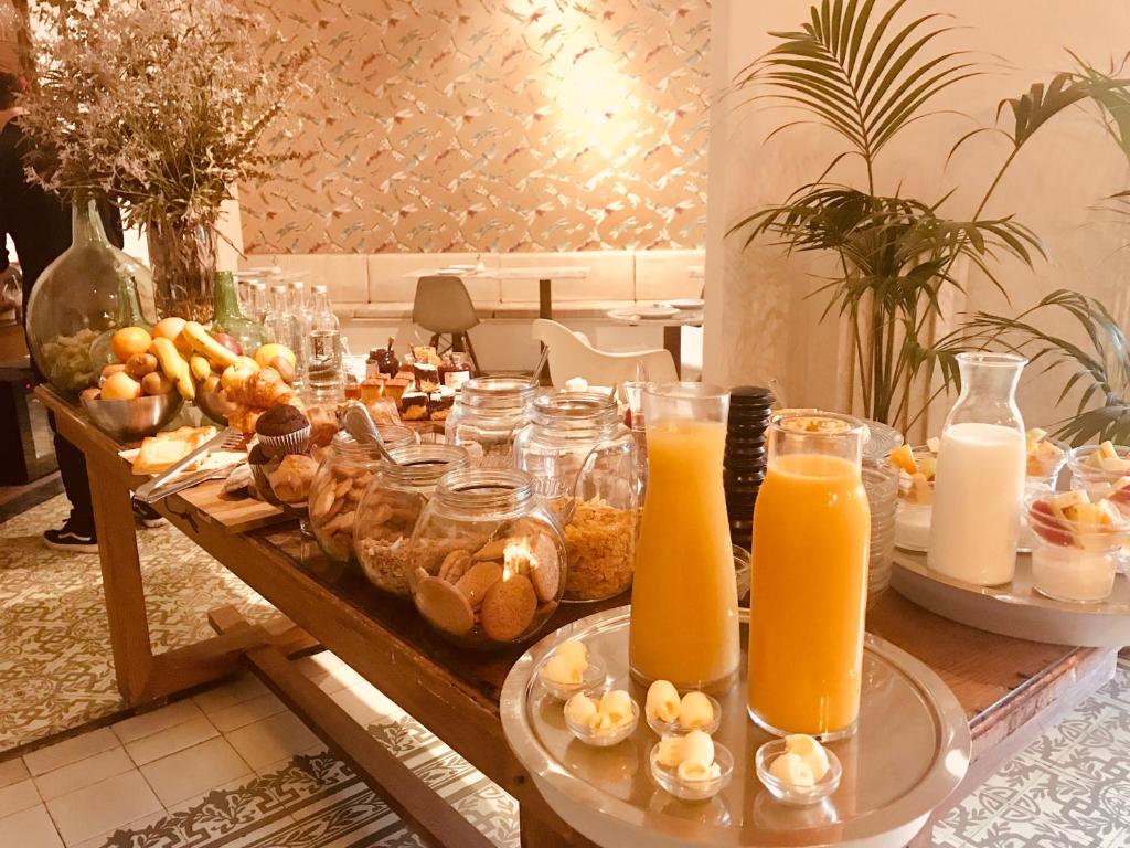 a table topped with lots of food and orange juice at Forget Me Not Barcelona in Barcelona