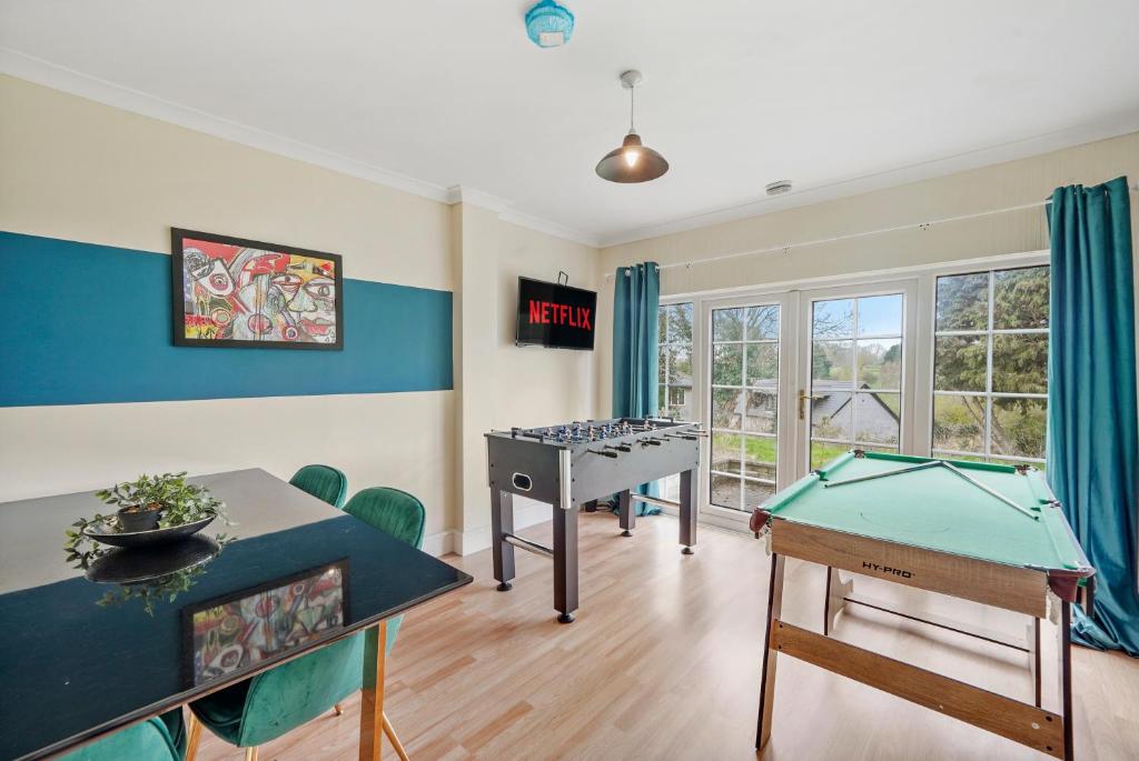 a room with a ping pong table and ping pong balls at Beautiful Boutique Derbyshire Abode - Games room in Derby