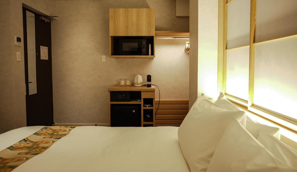 Postel nebo postele na pokoji v ubytování Miru Kyoto Gion