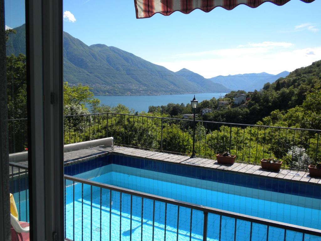 a view from the balcony of a house with a swimming pool at Casa Solaria in Gordola