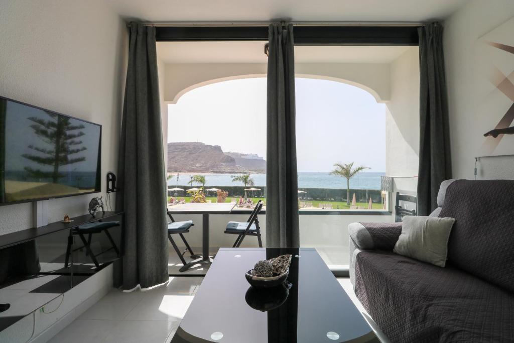 A television and/or entertainment centre at Seafront Playa del Cura apartment
