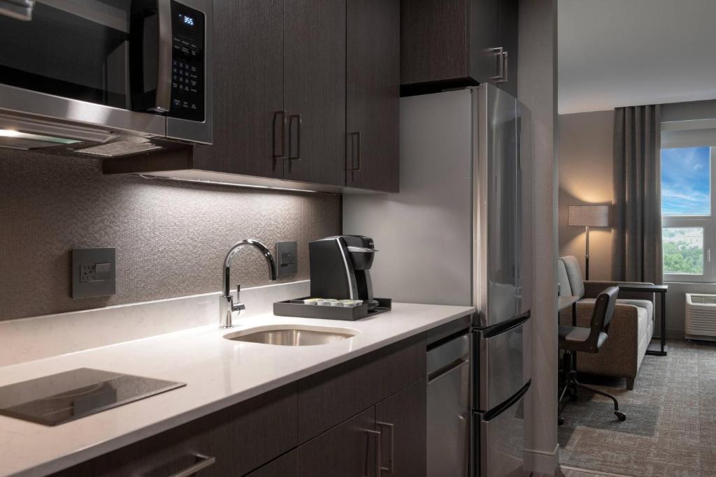 a kitchen with a sink and a microwave at TownePlace Suites by Marriott Boston Medford in Medford