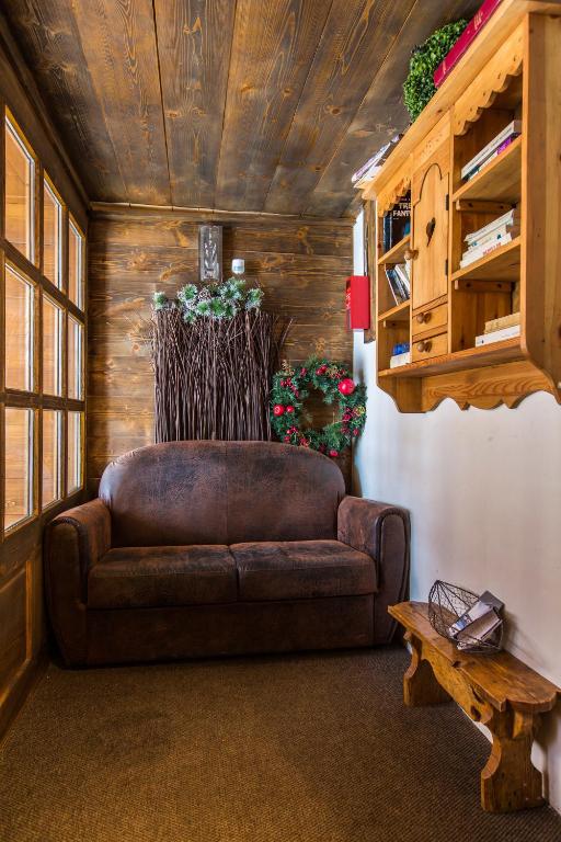 a living room with a brown couch and a table at Les Monts Charvin in Courchevel