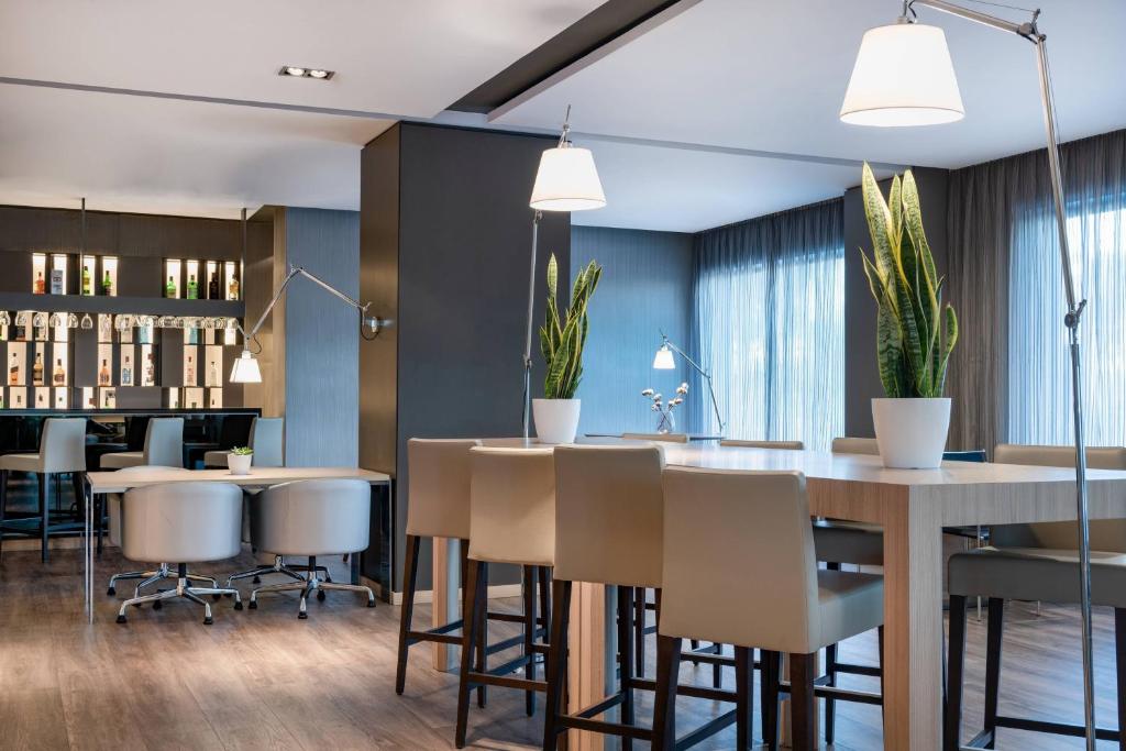 a dining room with a table and chairs at AC Hotel Huelva by Marriott in Huelva