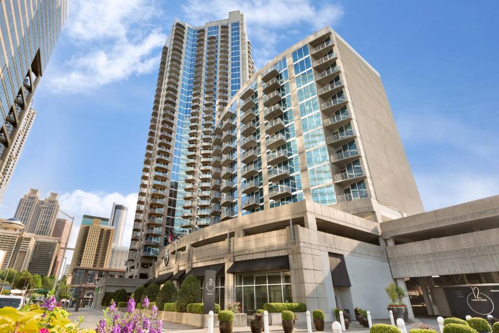 a tall building in a city with tall buildings at Twelve Downtown, Autograph Collection in Atlanta