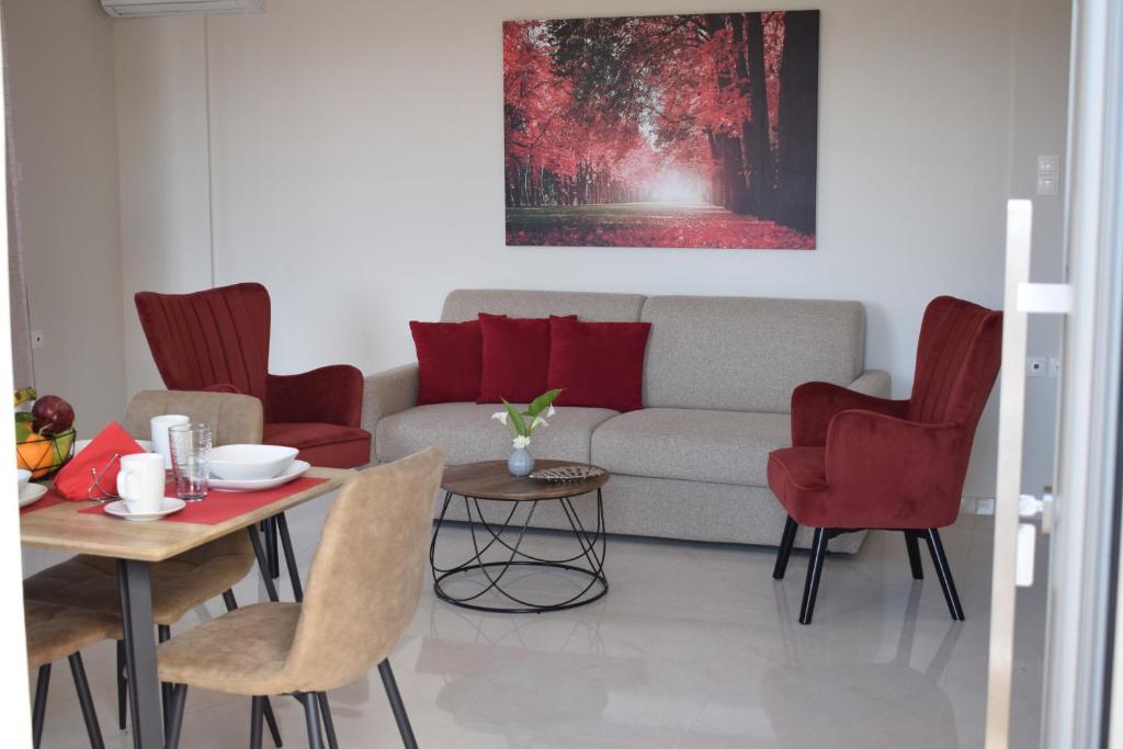 a living room with a couch and a table and chairs at Studio Holiday Kalamata 2 in Kalamata
